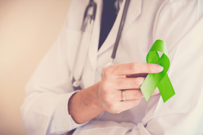 Doctor hands holding Lime Green ribbon, Mental health awareness Doctor hands holding Lime Green ribbon, Mental health awareness