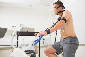 Man doing fitness test on exercise bike at the medical centre