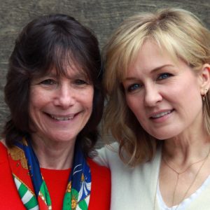 Two women, smiling and posing for camera.