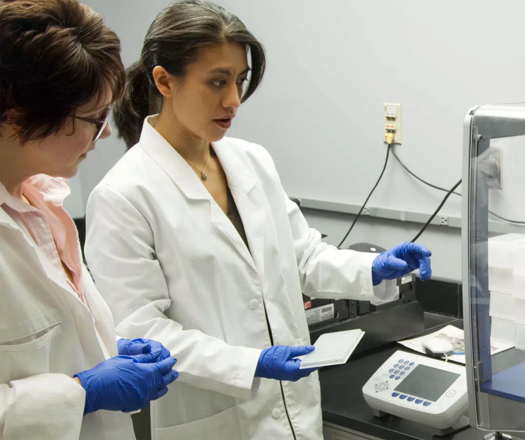 Older and younger women researchers looking right