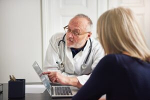 Woman having consultation with doctor at laptop