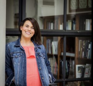 Woman smiling in a denim jacket