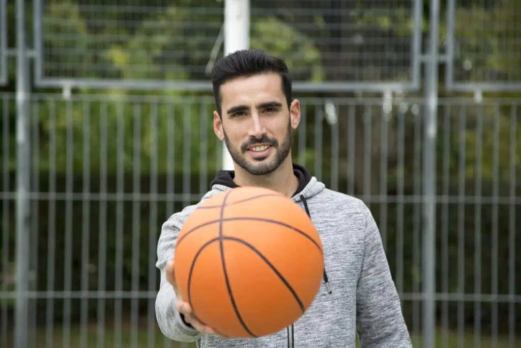 man with a basketball ball in a court