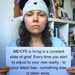 Liv is holding a sign that reads: ME/CFS is living in a constant state of grief. Every time you start to adjust to your new reality - to your latest loss - something else is taken away.