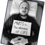 Niko Suvisto is holding a sign that reads: ME/CFS is the absence of life.