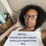 Rachael is holding a sign that reads: ME/CFS is feeling like your cells are dying, but somehow you’re supposed to keep living.