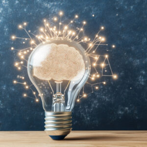 A light bulb with an illuminated brain design inside, surrounded by glowing interconnected lines.
